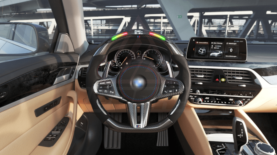 Front view of a BMW G/F chassis, M sport steering wheel in carbon fiber, black perforated leather, driving assistant buttons, m color accents and led shift lights